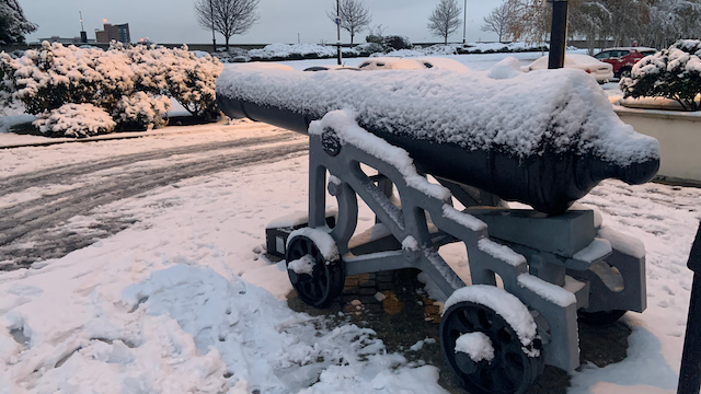 antique cannon covered in snow